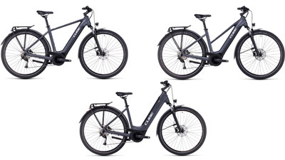 Zu sehen sind drei graue Cube Touring Hybrid ONE E-Bikes, jeweils mit einem Diamant-Rahmen, ein Trapez-Rahmen und ein Tiefeinsteiger-Rahmen.  